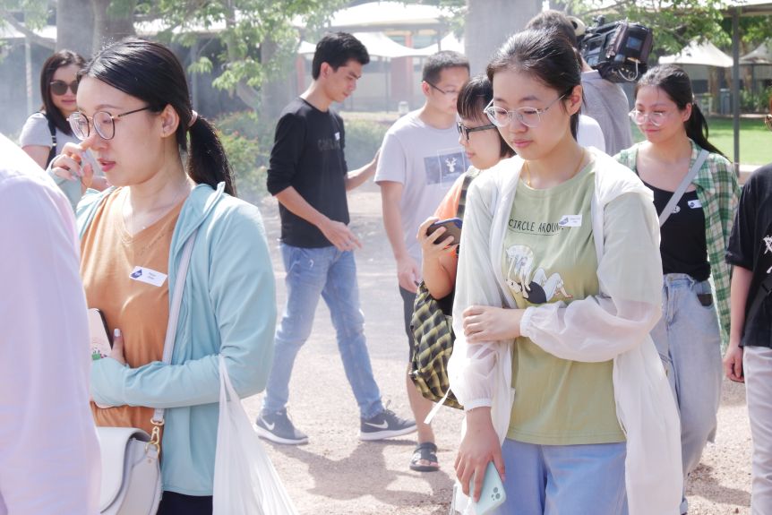 International students taking part in a welcoming Larrakia smoking ceremony on campus.